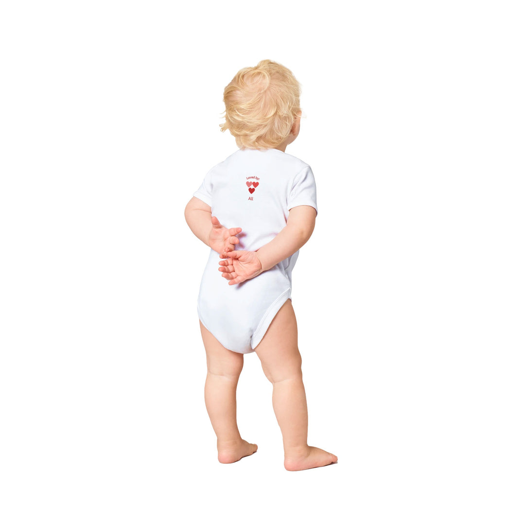 White baby bodysuit, three Pink hearts, Icelandic text 'Loved by All',on back customizable with baby's name on front.449128b0-1be7-474e-ab29-90d88f7116e6