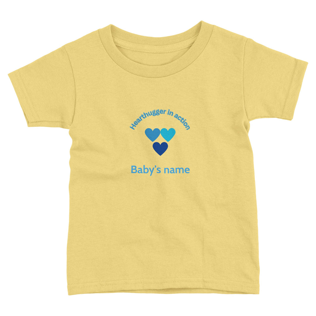 d69e6525-fbfd-463a-8e00-5e8c36808214 Toddler t-shirt with 'Hearthugger in Action' design, customizable with name on front, 'Loved by all' on the back." Sizing Chart: "Size chart for a toddler t-shirt with measurements in inches and centimeters."